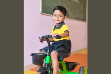 Child enjoying a tricycle activity