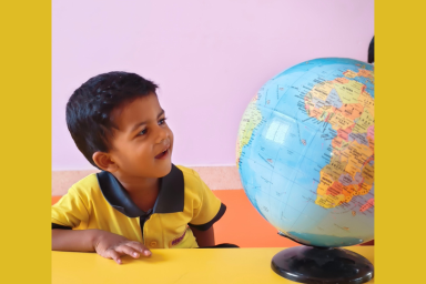 Child exploring a globe